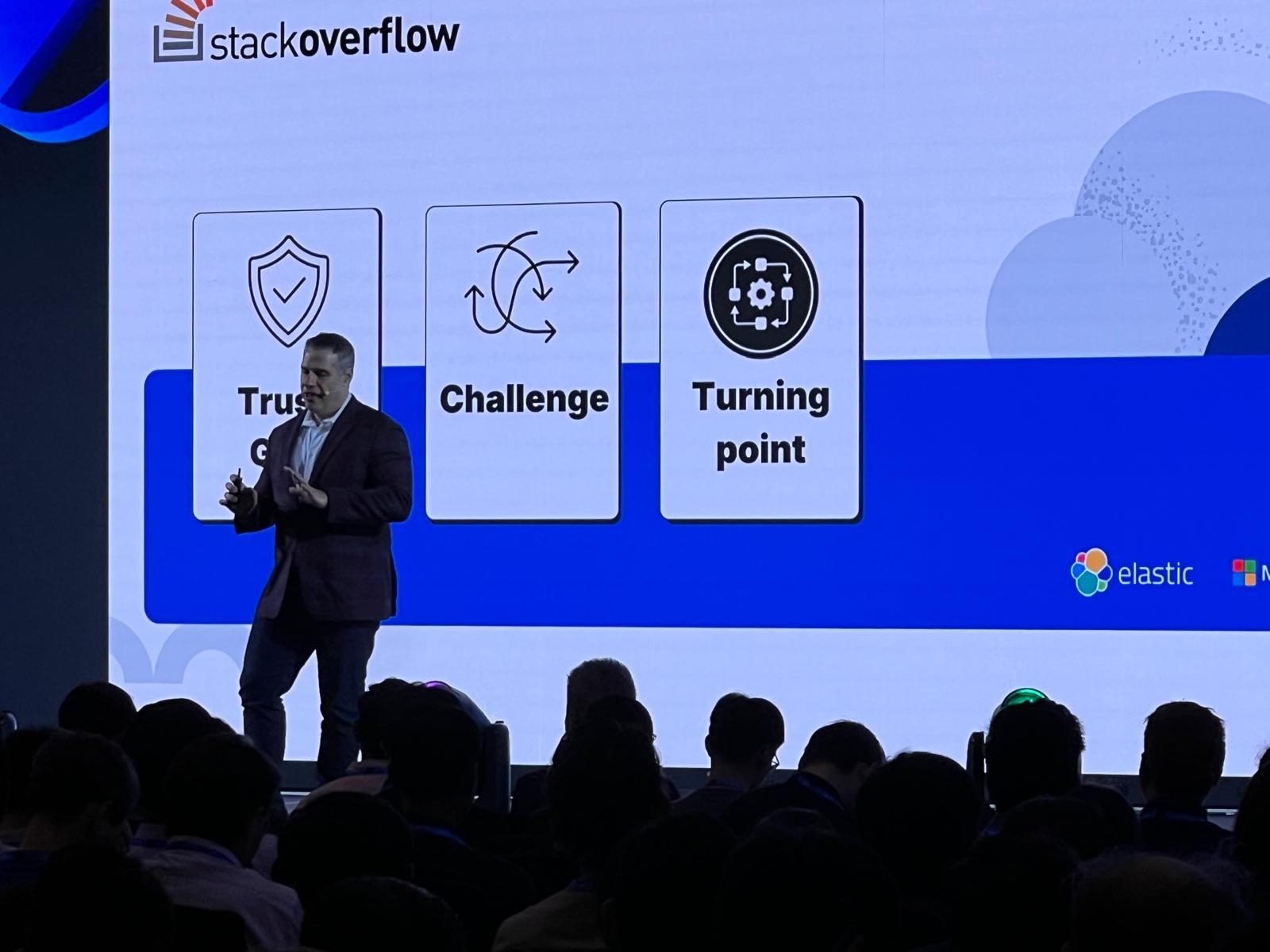 Mike Richter speaking with a handheld microphone on stage at ElasticON Singapore.